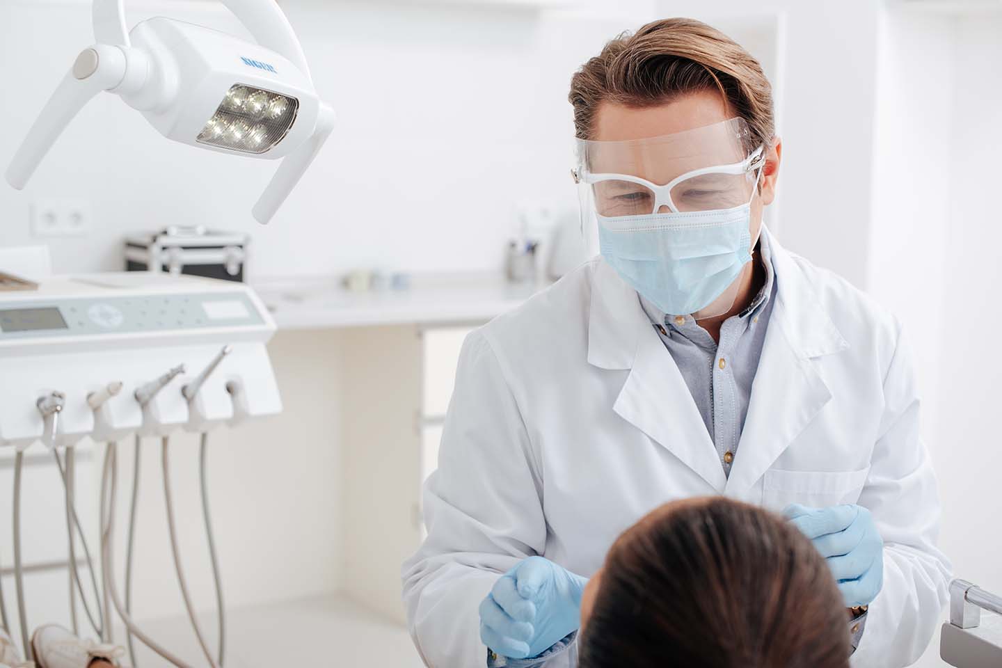 Dentist checking patient's mouth