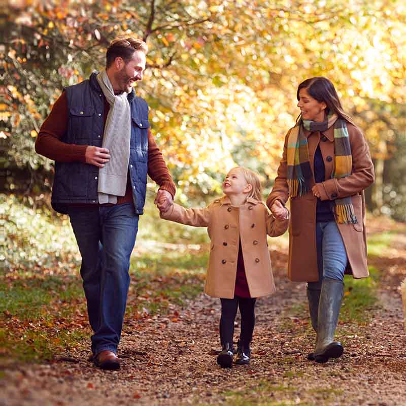 Family walking in park in autumn